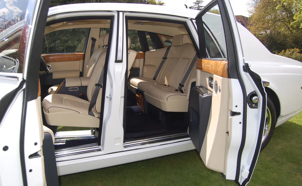 Interior of a white Phantom style wedding car with cream leather